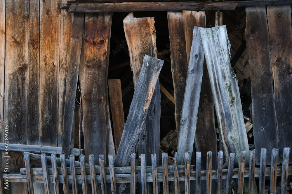 Old wooden fence on the background of an old wooden building