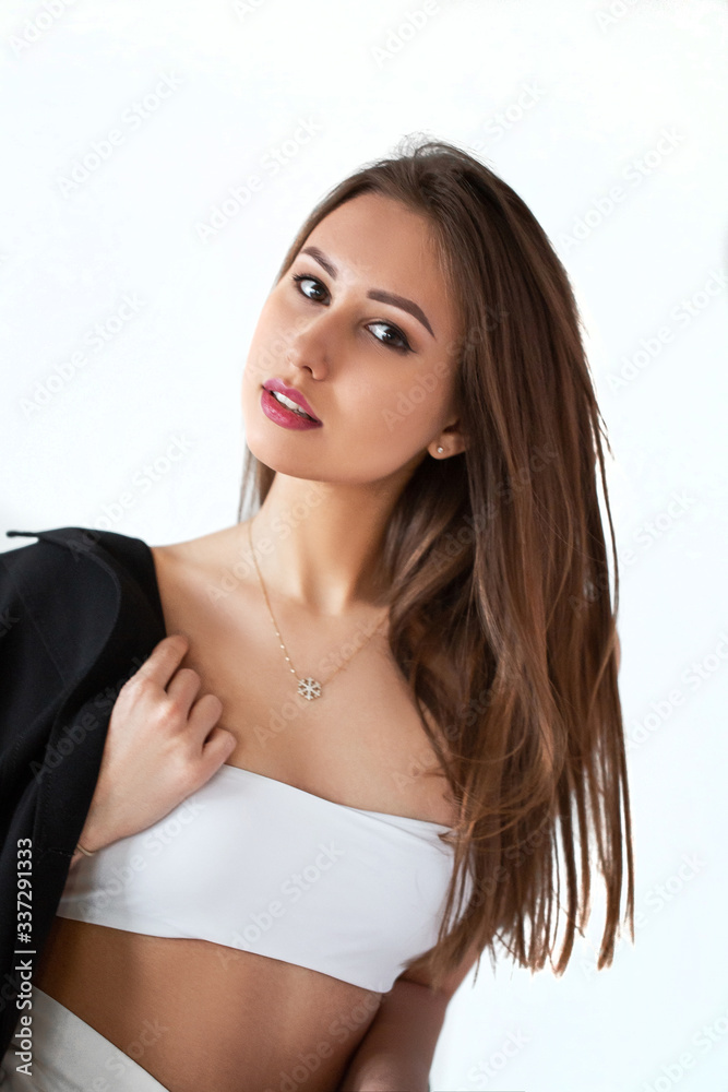 Obraz premium girl in white with a black jacket on a light background