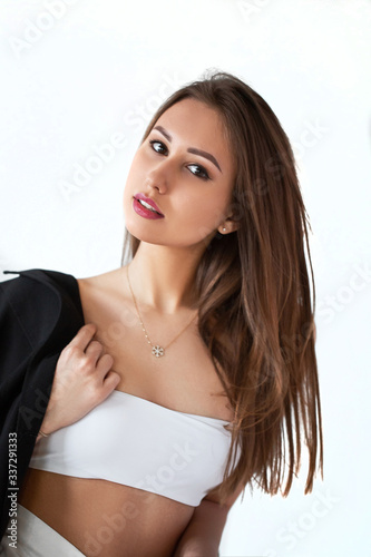 girl in white with a black jacket on a light background