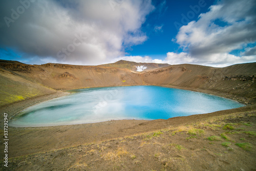 The mouth of a volcano crater filled with water in Iceland. Water Lake in the volcano caldera © luchschenF