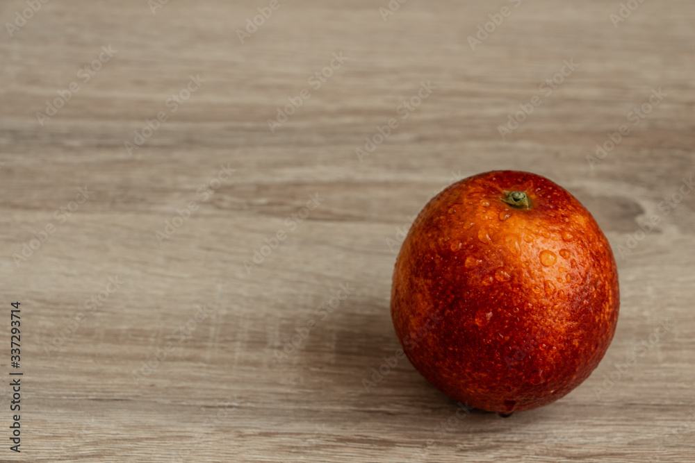 juicy red orange on a wooden table closeup, exotic fruit juicy red orange on a wooden table closeup, exotic fruit
