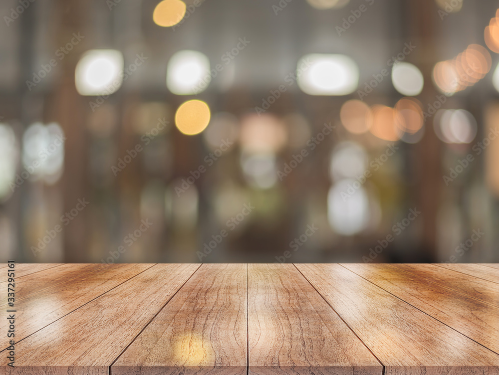 Wooden top table with bokeh light effect and blur restaurant on background, blur background