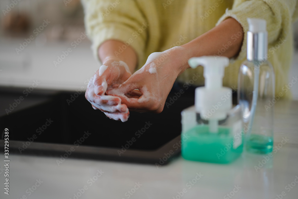 Crop shot of female hands washing properly with antibacterial soap during coronavirus pandemic cleaning from virus and bacteria. Concept of personal hygiene, disease prevention and healthcare