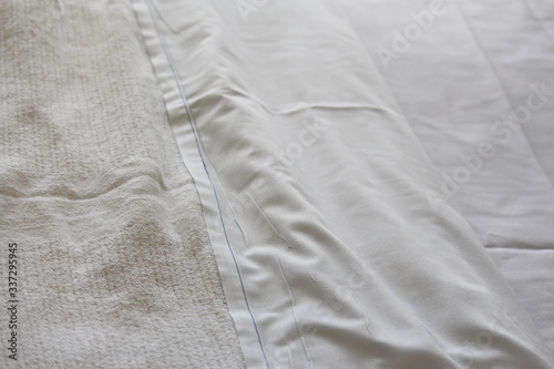 Close up of fresh white hospital sheet and blanket