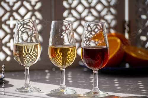 Glasses with cold dry fino and sweet cream sherry fortified wine in sunlights, a Fototapet