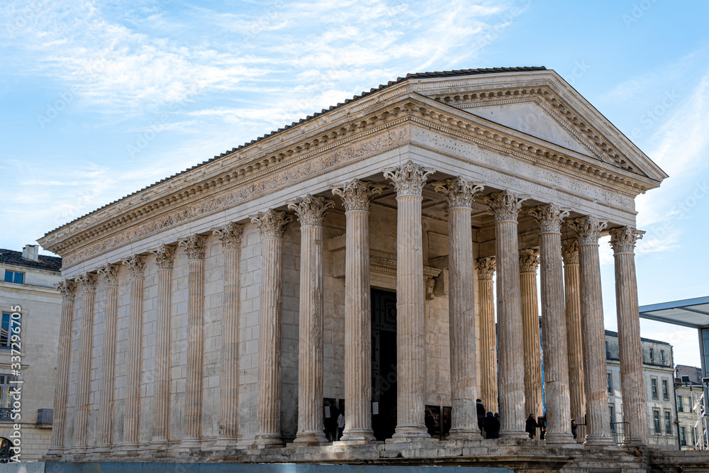 Roman pantheon in the city of Nimes, France at sunset