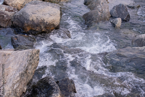 clear white water flowing between huge rocks
