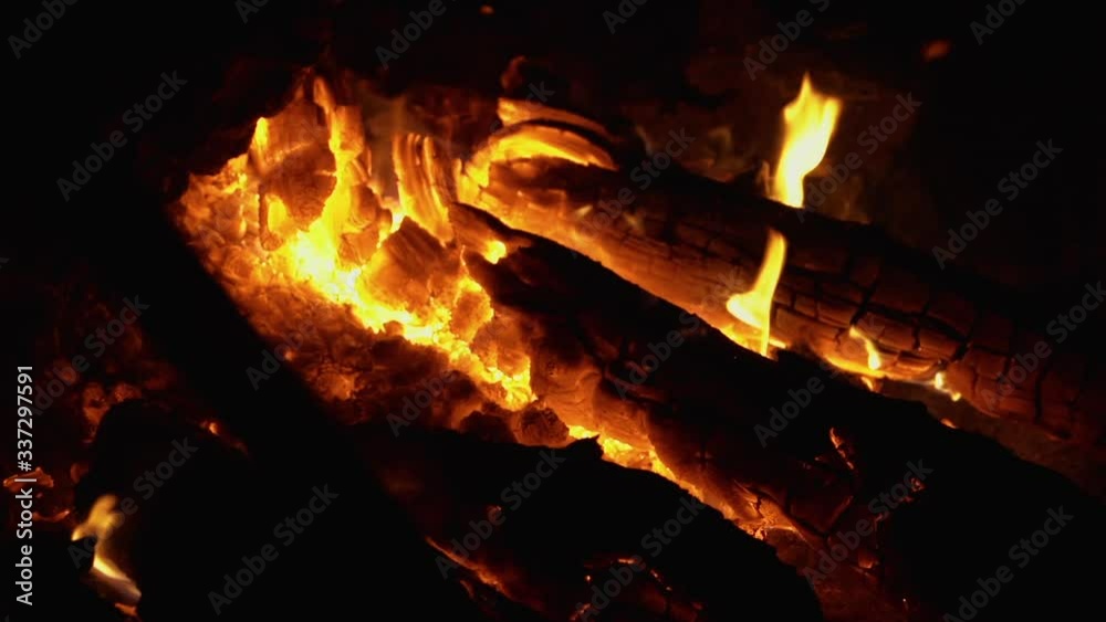 Fire flaming with firewood. Wide shot of flames in slow motions Fire flaming with firewood. Wide shot of flames in slow motions
