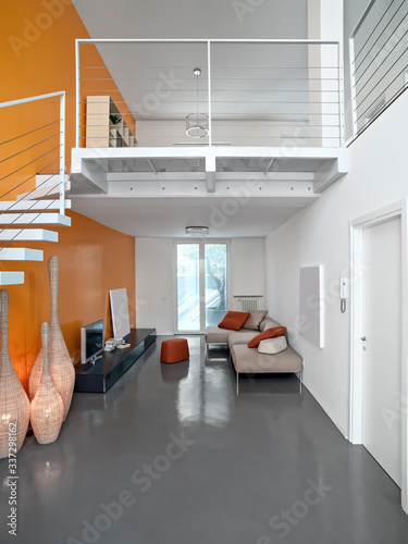 Konstfotografi Interiors of a Modern Living Room with Resin Floor and a Staricase