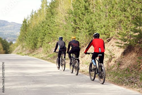 group of cyclists on a forest road