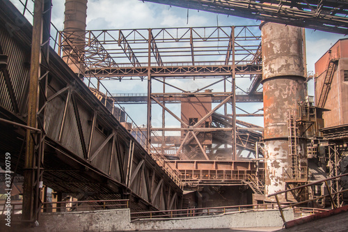General view of the sinter plant. Submission of iron ore for sintering before entering the blast furnace. Metallurgical production. Day panorama