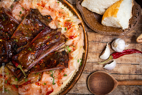 Fototapeta Naklejka Na Ścianę i Meble -  Dish of cabbage and smoked meat in rustic bowl