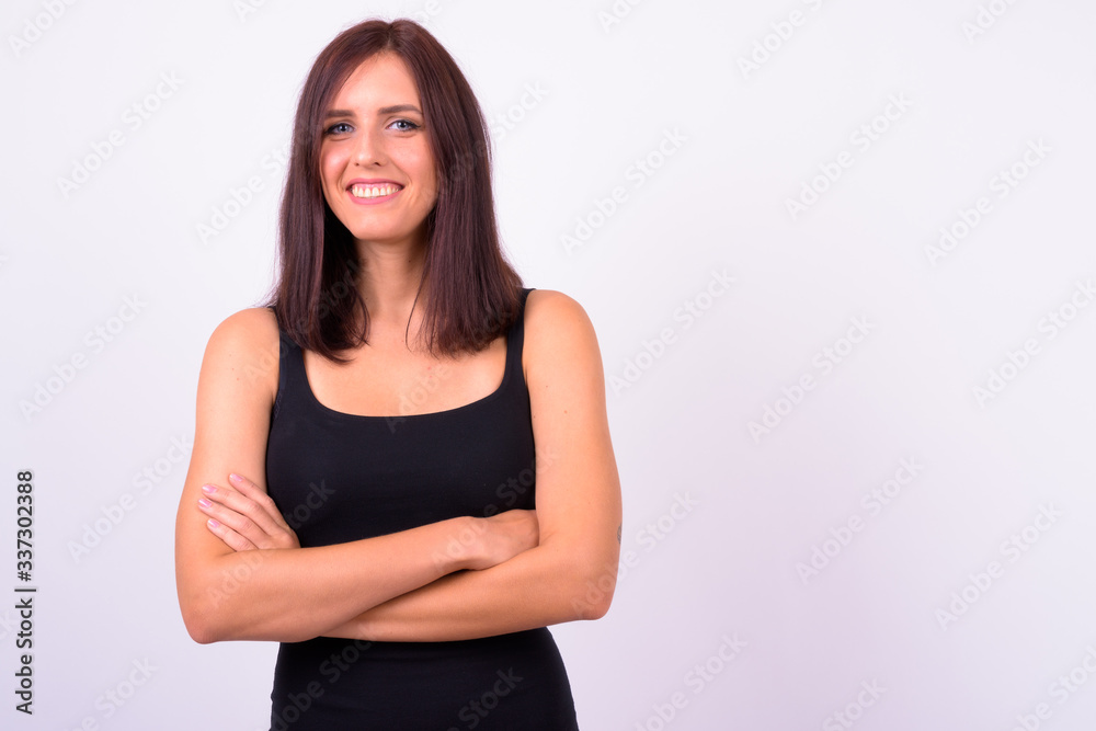 Portrait of happy young beautiful woman smiling with arms crossed Portrait of happy young beautiful woman smiling with arms crossed