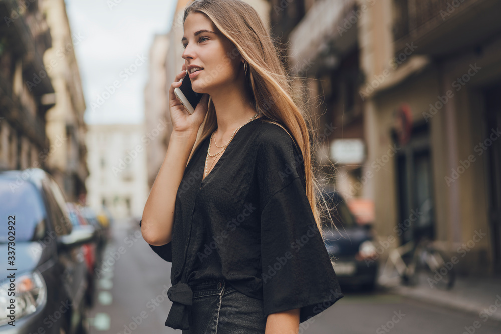 Young woman looks startled receiving some information by the call on her phone. She listen to the audio message and became happy hearing the voice of her friend. Girl is crossing the road. Young woman looks startled receiving some information by the call on her phone. She listen to the audio message and became happy hearing the voice of her friend. Girl is crossing the road.