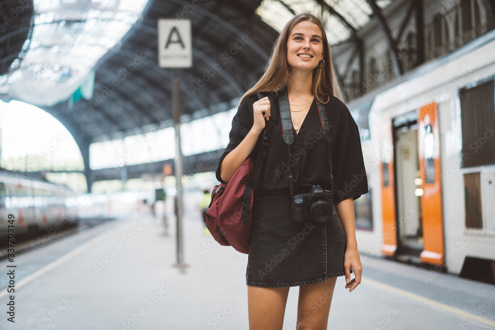 Girl get off the train and goes to the city, she bring a bag and a camera for the thavel. She walks through the platform and look around, she starts her trip in the new place. Girl get off the train and goes to the city, she bring a bag and a camera for the thavel. She walks through the platform and look around, she starts her trip in the new place.