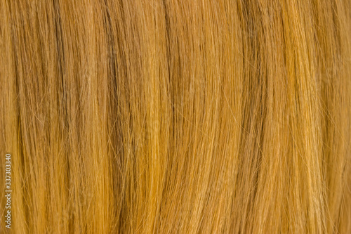 Red hair texture, close up. Hair pattern on a red background.