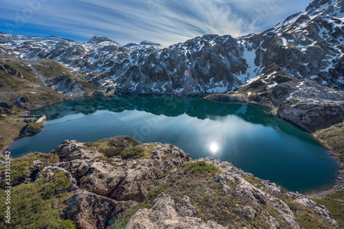 Fototapeta Naklejka Na Ścianę i Meble -  Lago de Calabazosa, Saliencia lakes in the Somiedo Nature Park, Asturias, Spain. End of winter with snowy areas in the mountains.