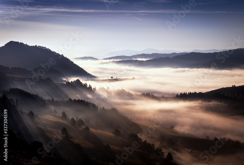Beautiful, colorful autumn panorama of Pieniny Mountains (Male Pieniny) in the fog and morning light . Poland, Slovakia.
