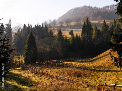 Beautiful, colorful autumn sunrise in The Pieniny Mountains (Male Pieniny) - view from the exit from the Homole Gorge towards the Wysoka peak, Jaworki, Poland. photo