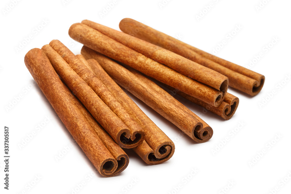 Bunch of delicious cinnamon sticks, isolated on white background