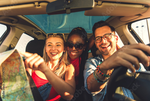 Three best friends enjoying at road trip traveling at vacation in the car. © Zoran Zeremski