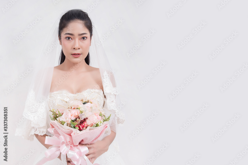 Asian woman is wearing wedding dress with free space on white background Asian woman is wearing wedding dress with free space on white background