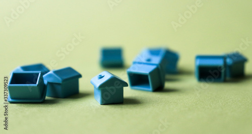 Blue figures of houses on a green background