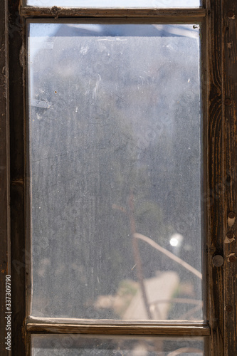 old wooden window with dirty glass