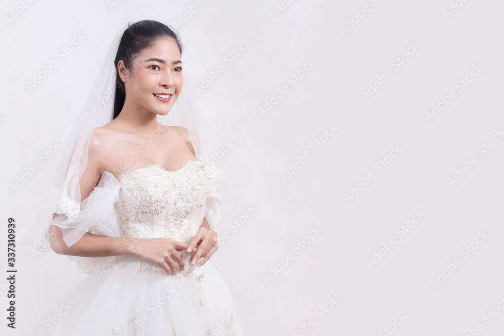 Asian woman is wearing wedding dress with free space on white background Asian woman is wearing wedding dress with free space on white background