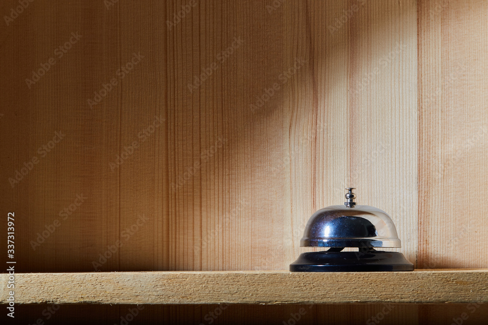 Bell of service on wooden background