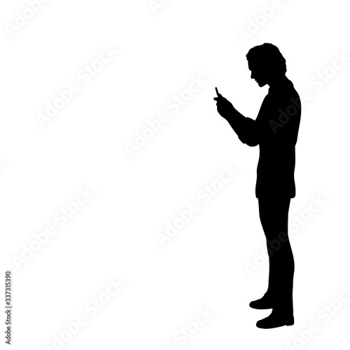 Silhouette of man looking at the phone