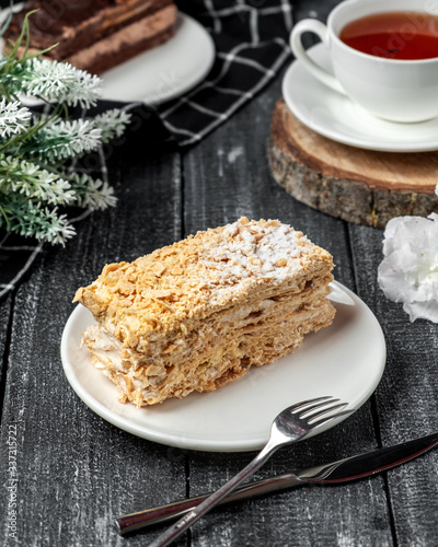 Canvas Print napoleon cake with black tea on the table
