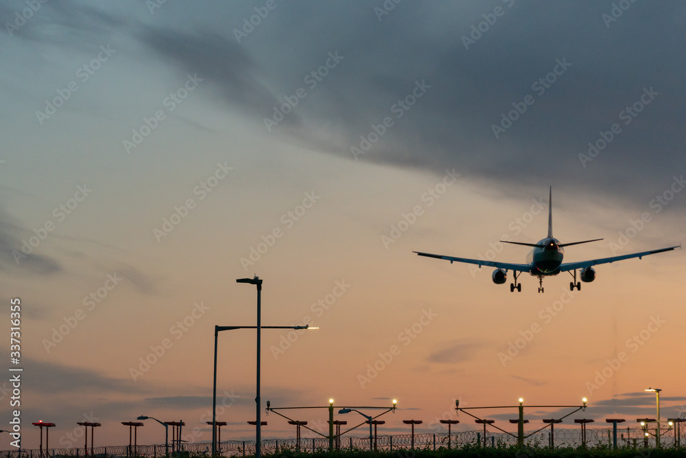 Airplane taking off from the airport runway at the sunset. Airplane taking off from the airport runway at the sunset.