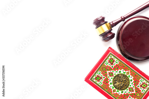 Photography Flatlay picture of Quran with law gavel on white background for sharia or Islamic law concept