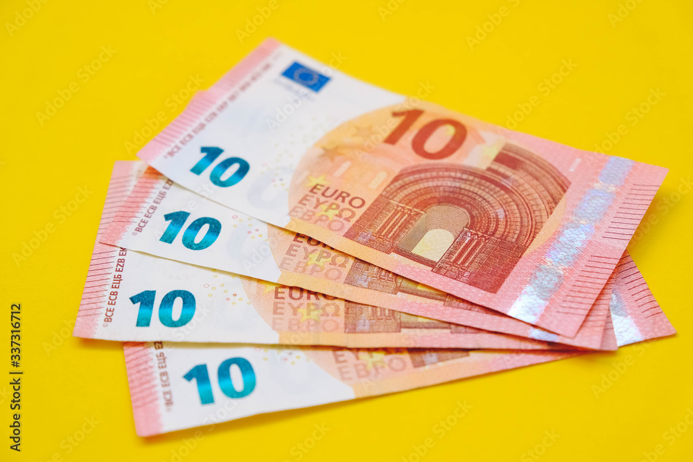Euro banknotes on a yellow background. Copy, empty space for text Euro banknotes on a yellow background. Copy, empty space for text