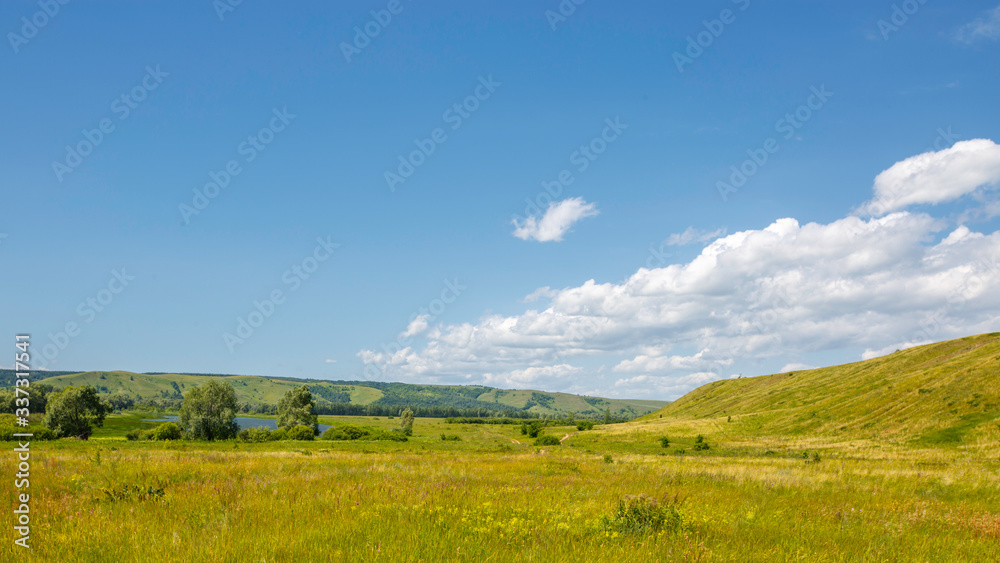 valley, meadow between hills with dirt country road