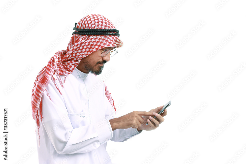 Arab business man wearing keffiyeh checking mobile phone isolated on white background. Arab business man wearing keffiyeh checking mobile phone isolated on white background.