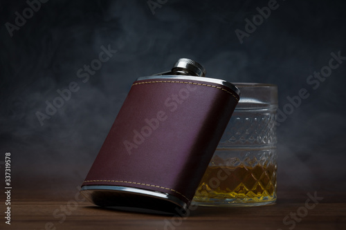 Leather Hip Flask resting on glass of whiskey