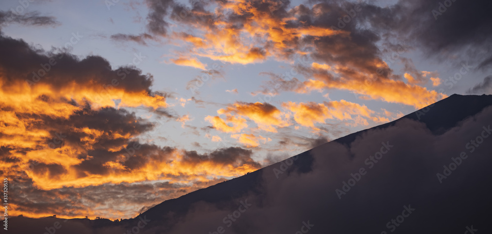 (Selective focus) Stunning view of the Mount Rinjani during a beautiful and dramatic sunset. Mount Rinjani (Gunung Rinjani) is an active volcano and the second highest mountain in Indonesia.