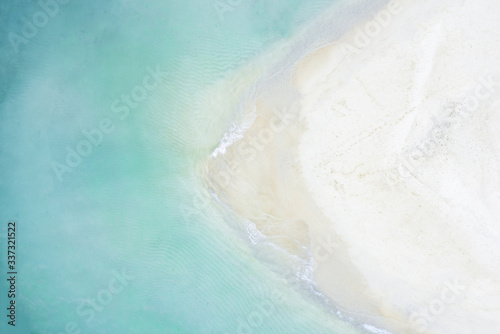 View from above, stunning aerial view of a white sand beach bathed by a beautiful turquoise sea. Tanjung Aan Beach, east of Kuta Lombok, West Nusa Tenggara, Indonesia.