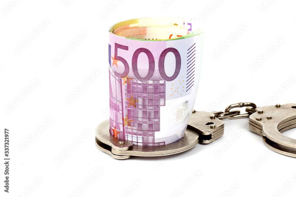 Money and handcuffs. Concept for corruption, fraud, money laundry Money and handcuffs. Concept for corruption, fraud, money laundry