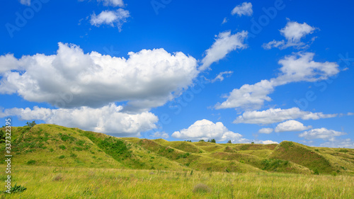 grass-covered hills above the valley on a sunny day © Андрей Пугачев