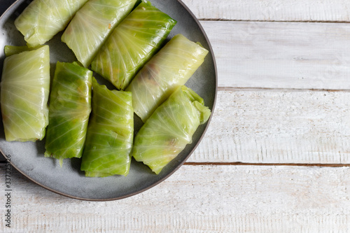 Cabbage rolls with stuff on plate on wooden background photo