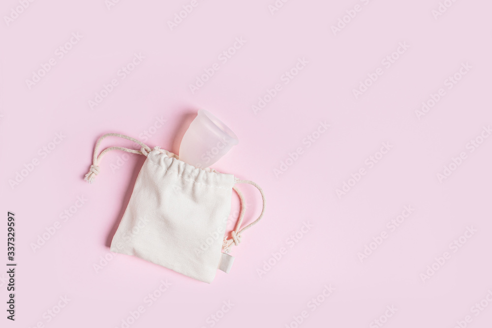 Fototapeta premium Silicone menstrual cup in a cotton bag. Reusable Intimate Hygiene.