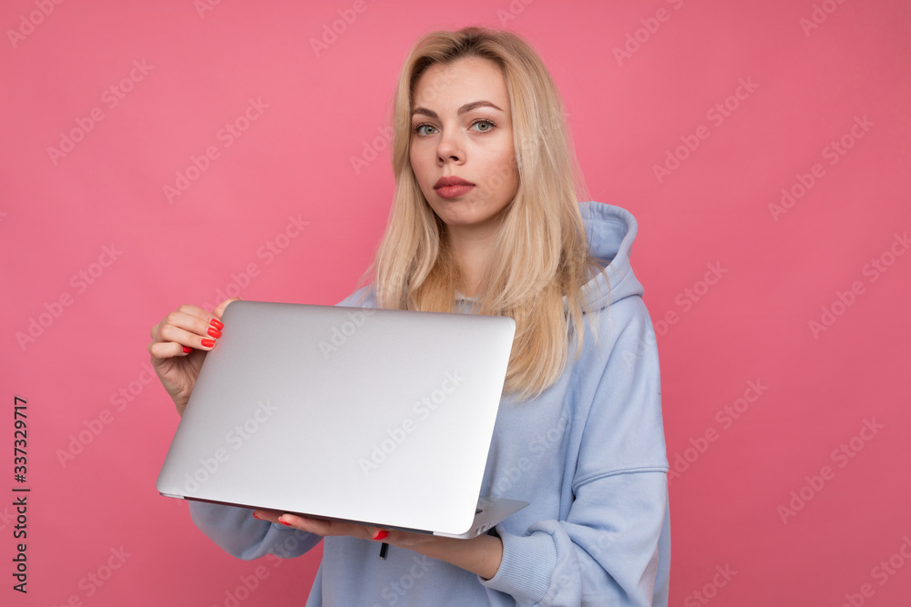A young girl holds a laptop in her hands . Concept of working outside the office A young girl holds a laptop in her hands . Concept of working outside the office
