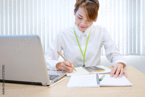 Modern young asian business woman working with laptop at workplace