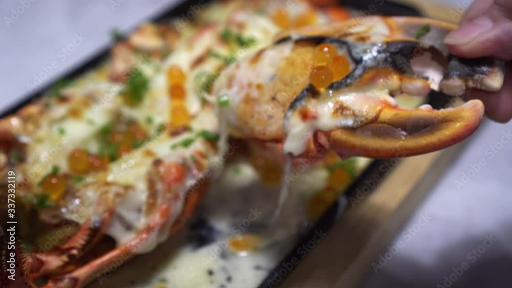 lobster cheese with salmon roe Hands taking claws lobster cheese with salmon roe Hands taking claws