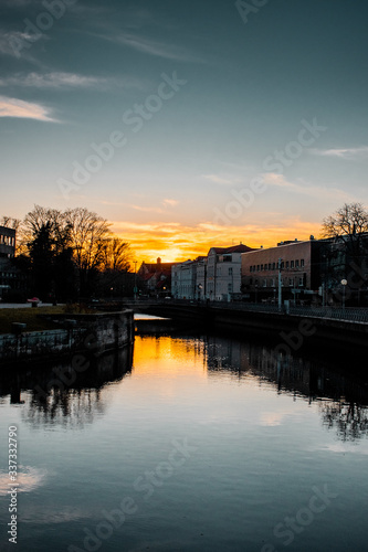 River in the downtown district at colorful moody evening sunset light and water reflection. Calm and empty evening scene. Downtown of a city, Braunschweig , Germany © Ricardo