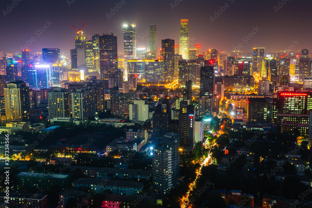 Naklejka premium Futuristic city at night. Many high-rises and neon signs.