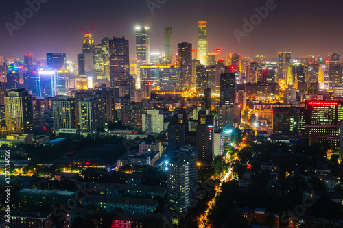 Futuristic city at night. Many high-rises and neon signs.